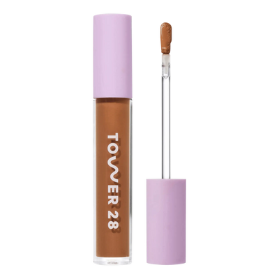 Tower 28 Beauty Swipe Serum Concealer in the shade 16.0 SB, shown with the tube standing upright next to the open applicator wand to reveal the product. [16.0 SB]