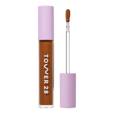 Tower 28 Beauty Swipe Serum Concealer in the shade 18.0 SGV, shown with the tube standing upright next to the open applicator wand to reveal the product. [18.0 SGV]