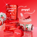 Red packaging of Tower 28 poppi with cranberry-themed items on a red background [Shared]