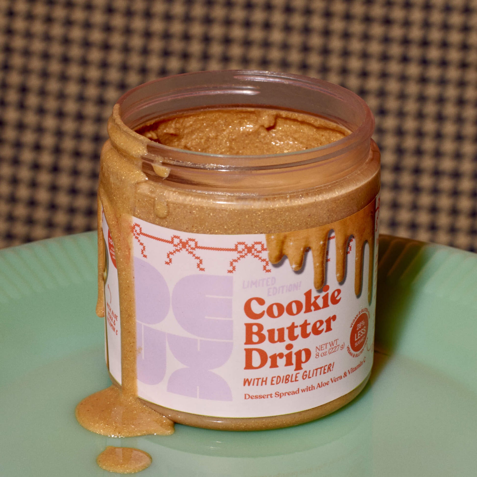 [Shared: Tower 28 Beauty's limited edition Cookie Butter collaboration with DEUX on a green dinner plate with shimmery cookie butter spilling out of the jar.