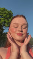 [A model applying a full face of Tower 28 Beauty makeup products outdoors. Products include SunnyDays Tinted SPF, MakeWaves Mascara, and BeachPlease Cream Blush.]