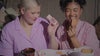 Tower 28 Beauty Holiday Drip 2023 Campaign - Video Montage of 2 Girls Applying ShineOn Lip Jelly and eating Tower 28 x DEUX Cookie Butter Drip, Wearing the purple Tower 28 x Comfy Original Wearable Blanket, and Tower 28 Toasty Toes Socks 