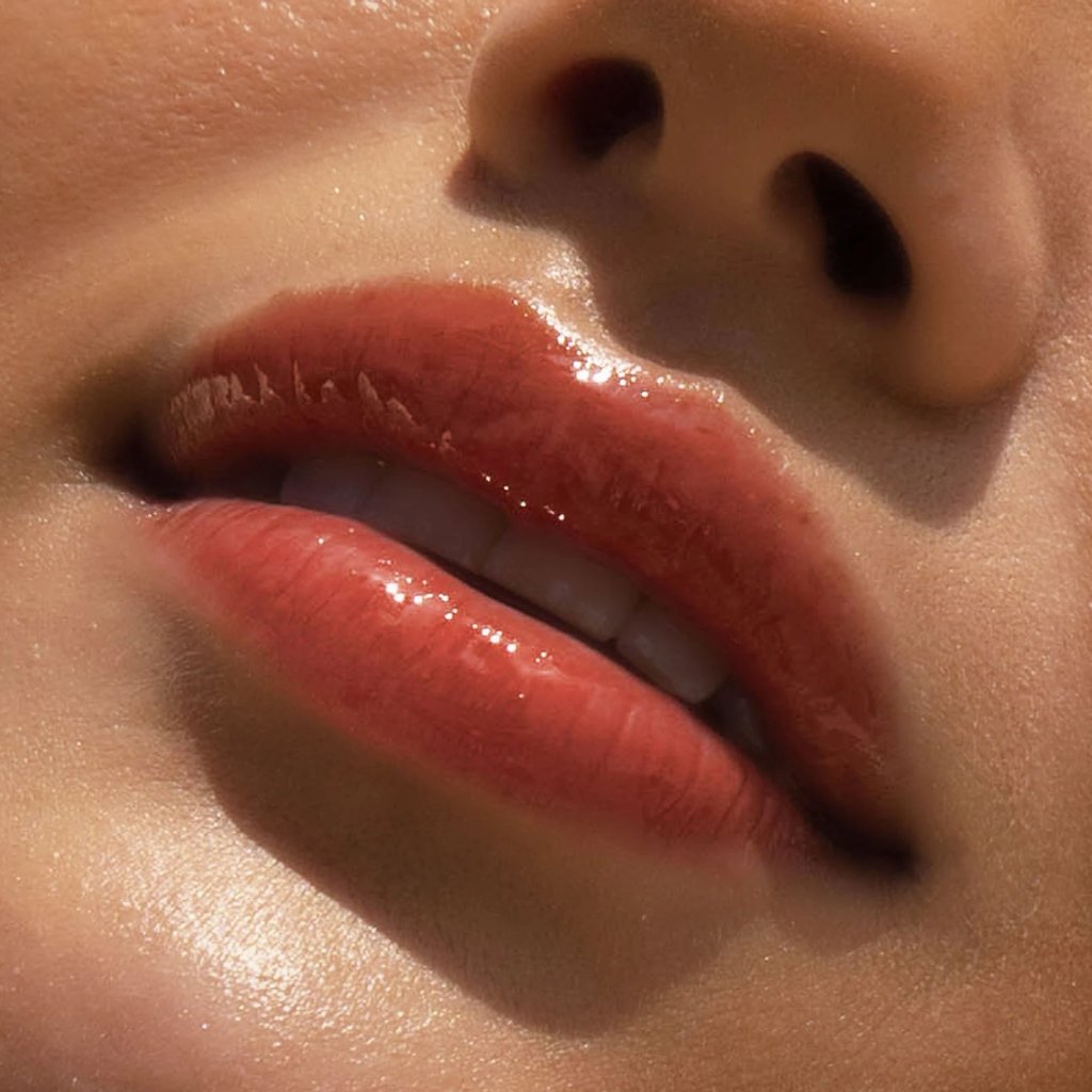 Fire [A model wearing the Tower 28 Beauty ShineOn Lip Jelly in the shade Fire on her lips]