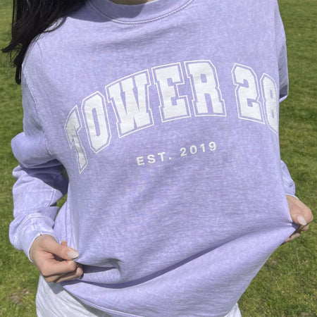 [Shared: Tower 28 Beauty Varsity Crewneck in vintage acid wash purple worn on a model]