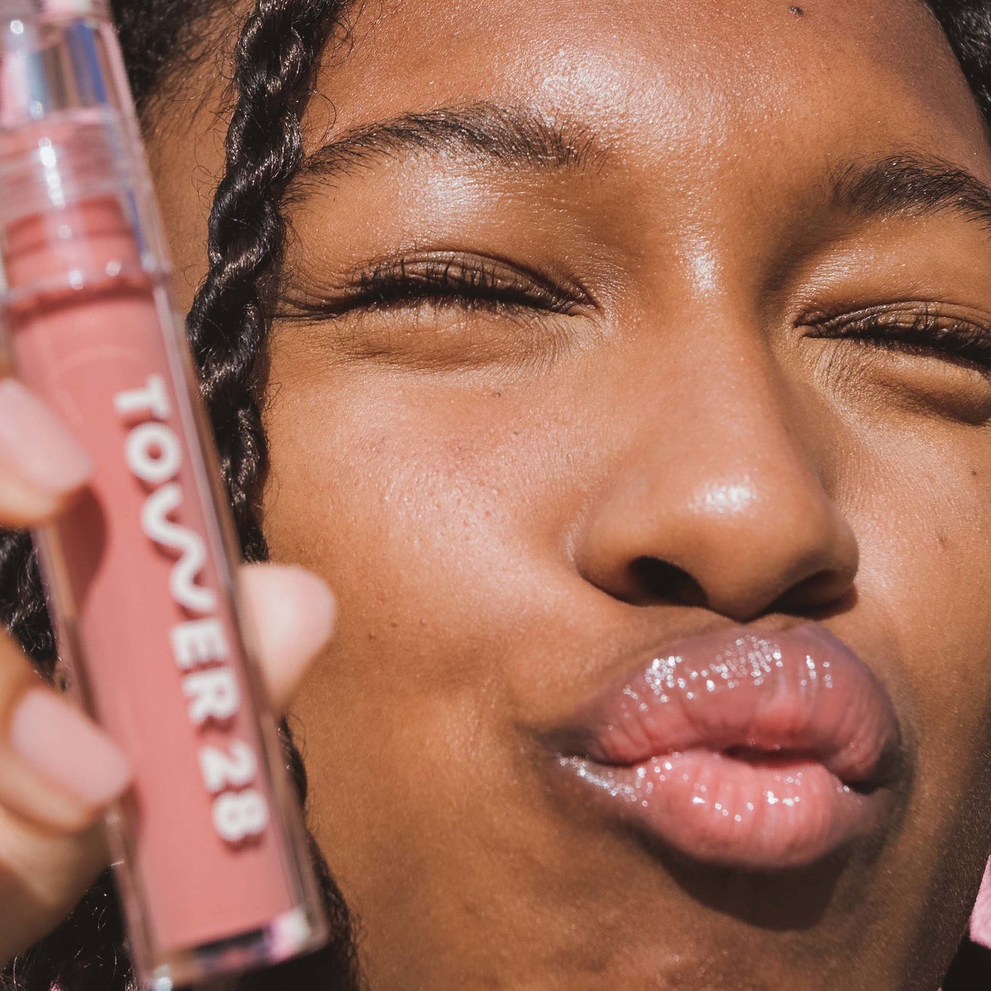 [Shared: Closeup photo of very glossy lips, smiling and wearing the Tower 28 Beauty ShineOn Milky Lip Jelly shade in Oat (a milky peachy-pink)]