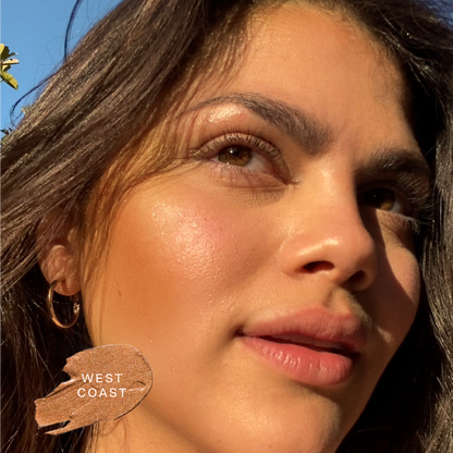 Shade: West Coast [A close up of a model wearing Tower 28 Beauty's Bronzino™ Cream Bronzer in the shade West Coast]