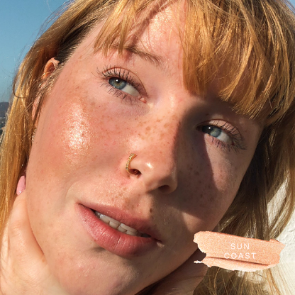Shade: Sun Coast [A close up of a model wearing Tower 28 Beauty's Bronzino™ Cream Bronzer in the shade Sun Coast]