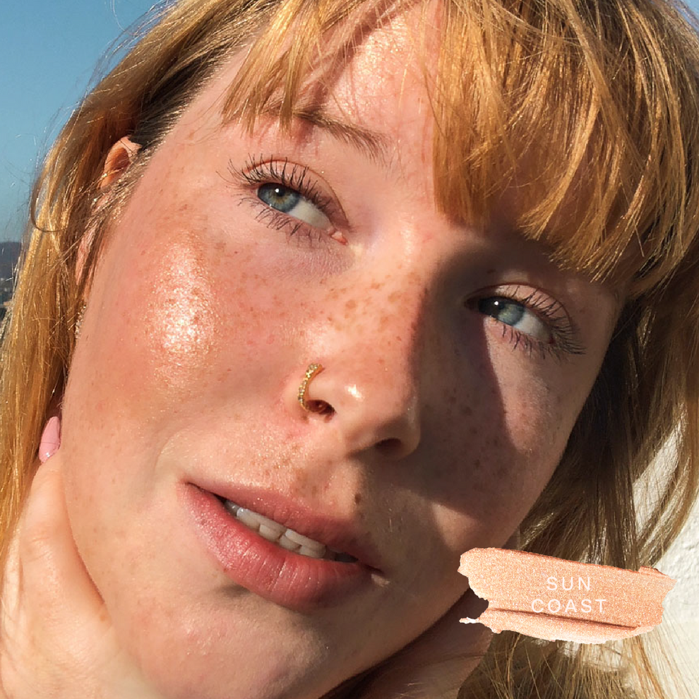 A close up of a model wearing Tower 28 Beauty's Bronzino™ Cream Bronzer in the shade Sun Coast