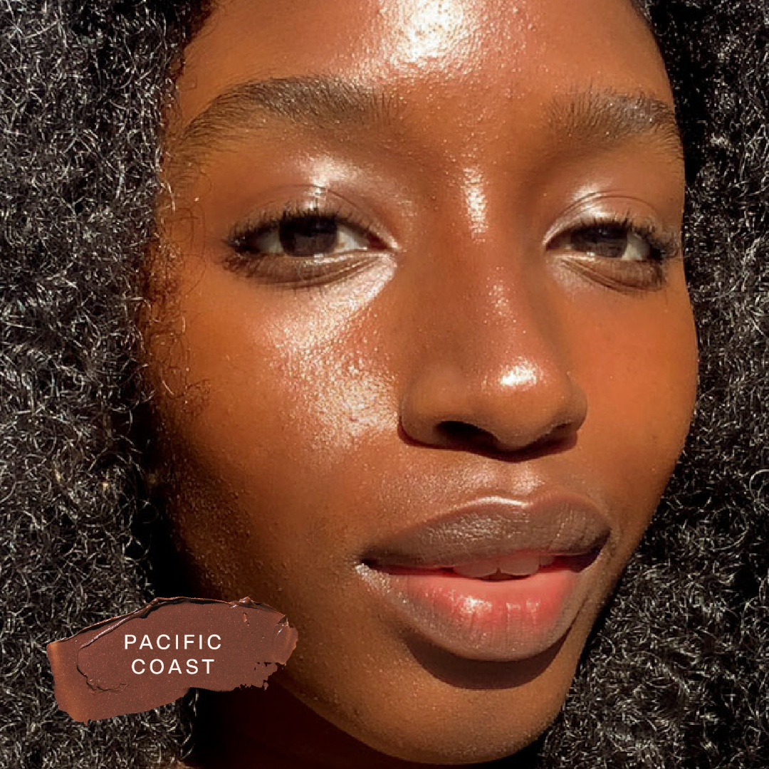 A close up of a model wearing Tower 28 Beauty's Bronzino™ Cream Bronzer in the shade Pacific Coast